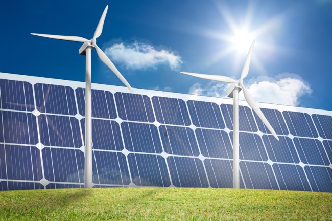 Wind turbines and solar panels in a green field